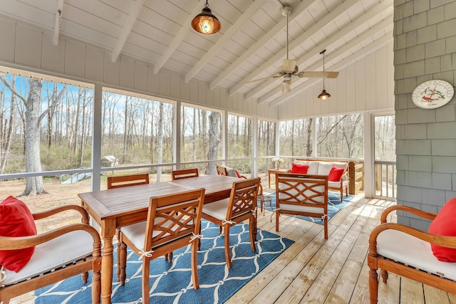 sunroom / solarium featuring wood ceiling, a forest view, vaulted ceiling with beams, and ceiling fan