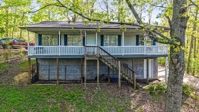 back of house featuring stairway and a porch