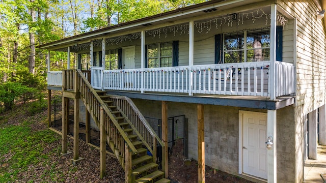 exterior space featuring covered porch and stairs