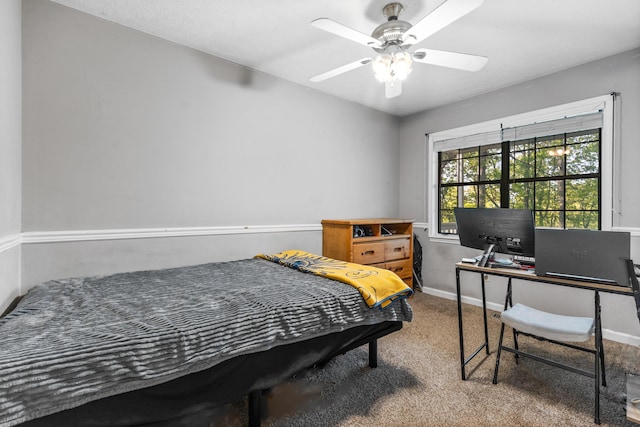 carpeted bedroom with a ceiling fan and baseboards
