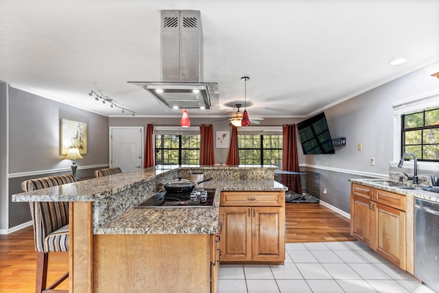 kitchen featuring crown molding, a sink, island range hood, dishwasher, and black electric cooktop