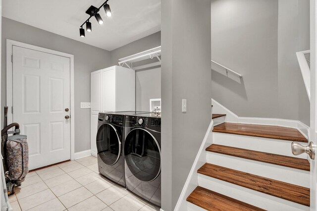 1010 Bradford Pl, Cohutta, GA 30710 - washroom featuring washing machine and dryer, cabinet space, light tile patterned flooring, and baseboards