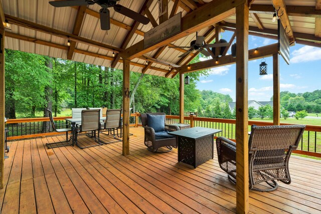1010 Bradford Pl, Cohutta, GA 30710 - wooden terrace with ceiling fan, outdoor dining space, view of scattered trees, and a gazebo