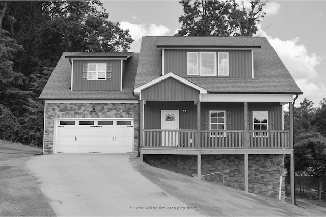 view of front of house featuring a garage, covered porch, stone siding, driveway, and roof with shingles