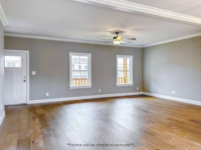 empty room featuring ornamental molding, ceiling fan, baseboards, and wood finished floors