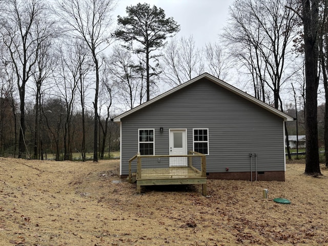 back of property featuring a wooden deck