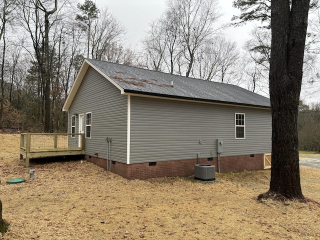 view of property exterior with a deck and central AC unit