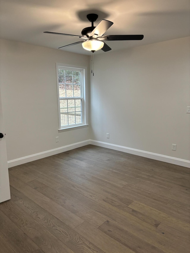 empty room featuring dark hardwood / wood-style floors and ceiling fan