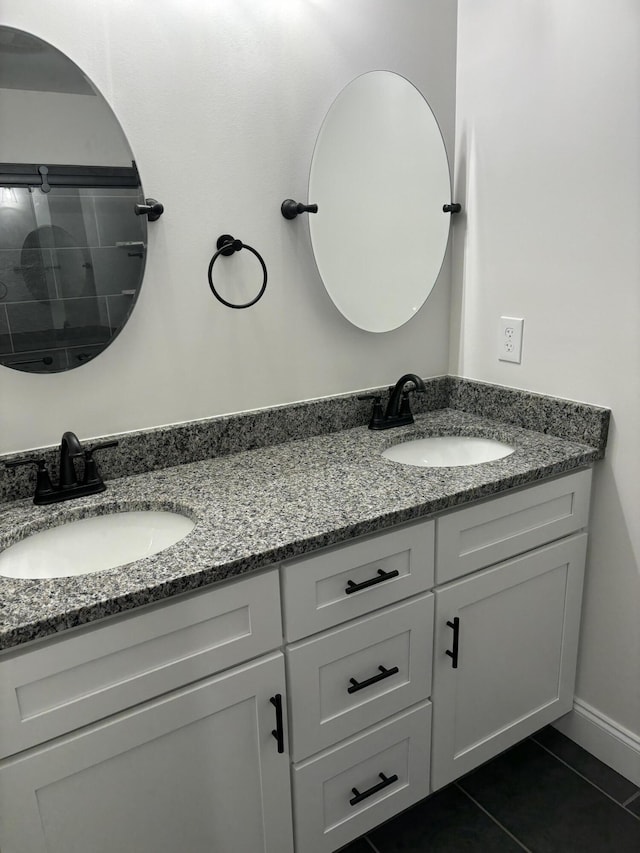 bathroom featuring tile patterned flooring and vanity