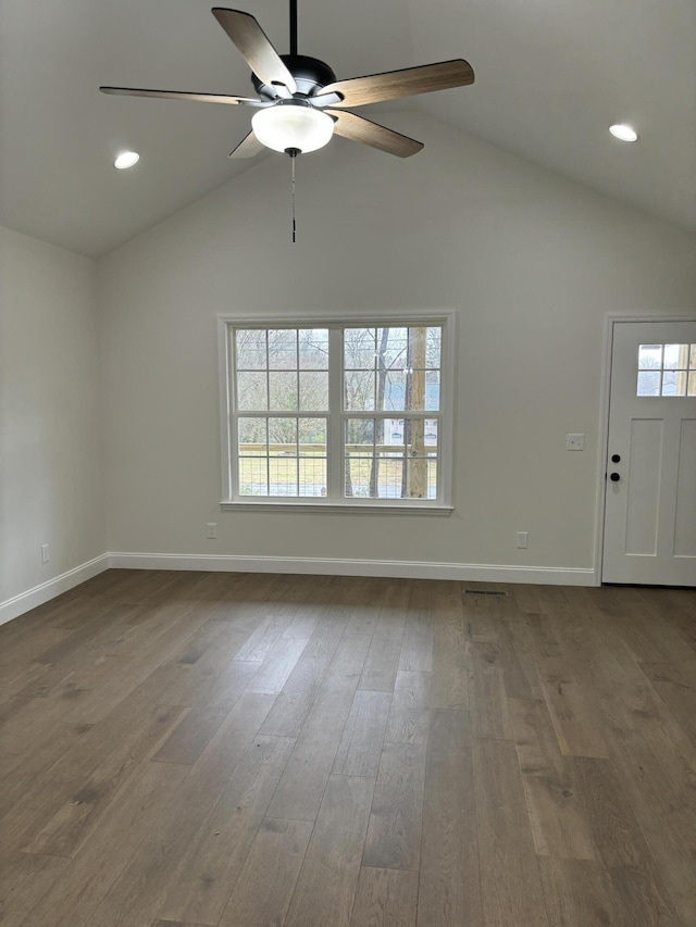 interior space featuring a wealth of natural light, wood-type flooring, and vaulted ceiling