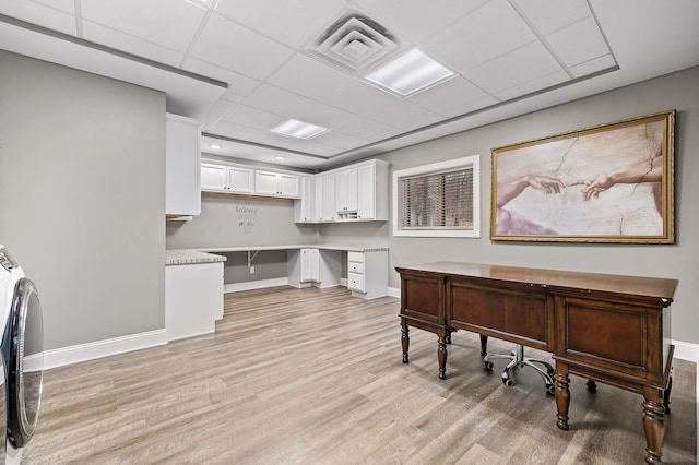 office space with light hardwood / wood-style floors and a drop ceiling