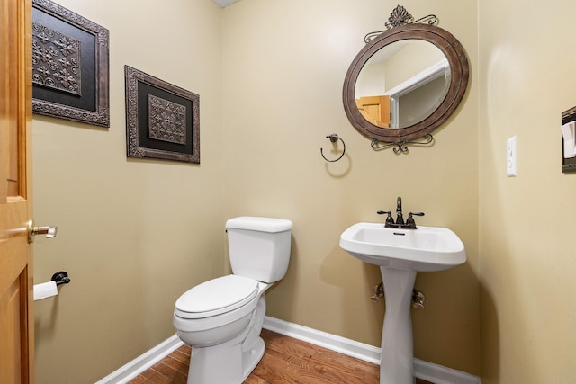 bathroom featuring sink, hardwood / wood-style floors, and toilet