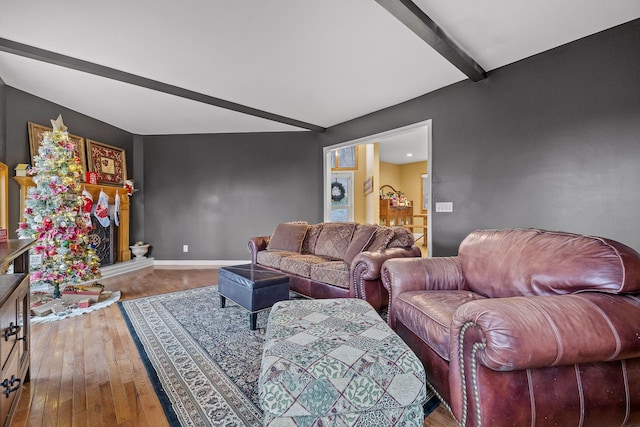 living room with beam ceiling and hardwood / wood-style flooring