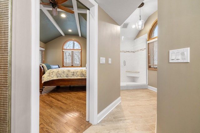 interior space featuring light hardwood / wood-style floors and lofted ceiling