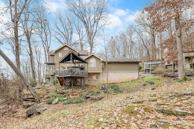 back of house featuring a wooden deck