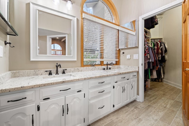 bathroom with vanity and lofted ceiling