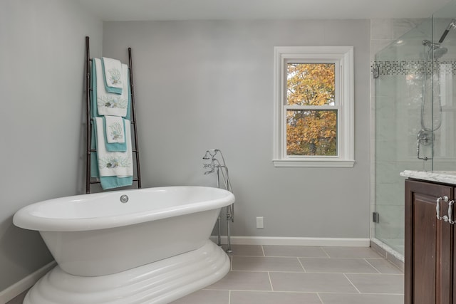 bathroom with tile patterned flooring, vanity, and shower with separate bathtub