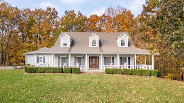 new england style home with covered porch and a front yard