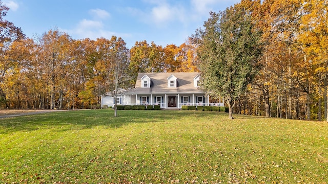 cape cod home featuring a front yard and a porch