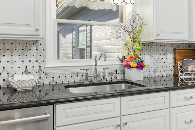 kitchen featuring backsplash, sink, white cabinets, and a healthy amount of sunlight