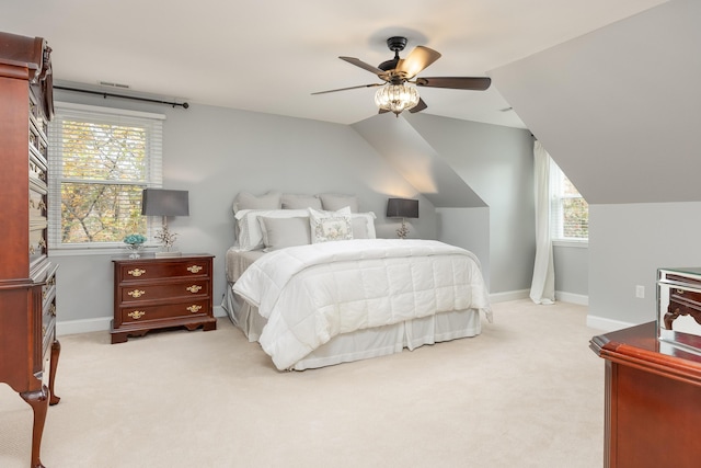 carpeted bedroom featuring multiple windows, ceiling fan, and lofted ceiling