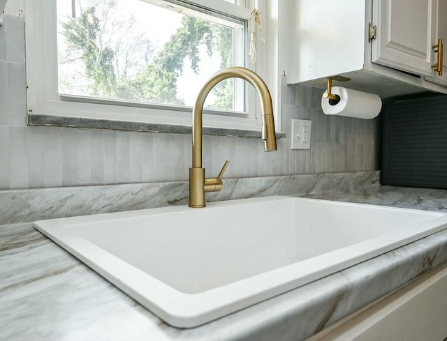interior details featuring light countertops and a sink