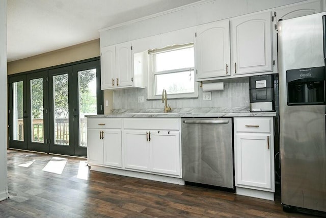kitchen with ornamental molding, dark wood-type flooring, a sink, white cabinets, and appliances with stainless steel finishes