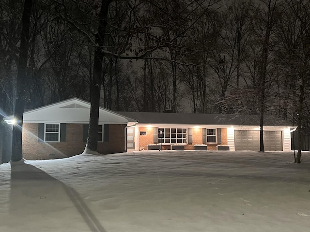 single story home with driveway, crawl space, a garage, and brick siding