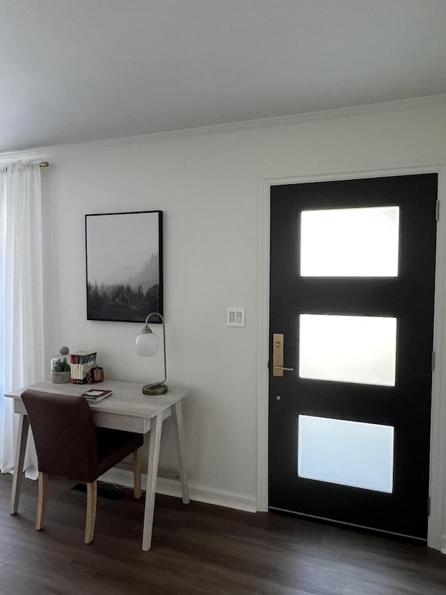 foyer featuring baseboards, ornamental molding, and dark wood-style flooring