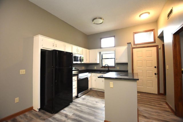 3800 Provence St Unit 10, Chattanooga, TN 37411 - kitchen with appliances with stainless steel finishes, dark countertops, dark wood finished floors, white cabinetry, and baseboards