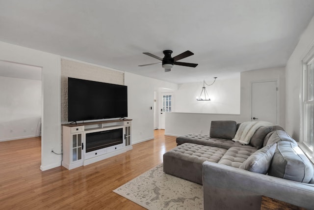 living room featuring ceiling fan and light hardwood / wood-style floors