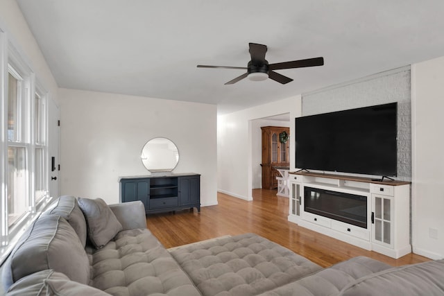 living room with light wood-type flooring and ceiling fan