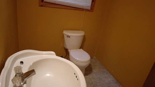 bathroom featuring tile patterned floors, toilet, and sink