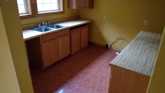 kitchen with light tile patterned floors and sink