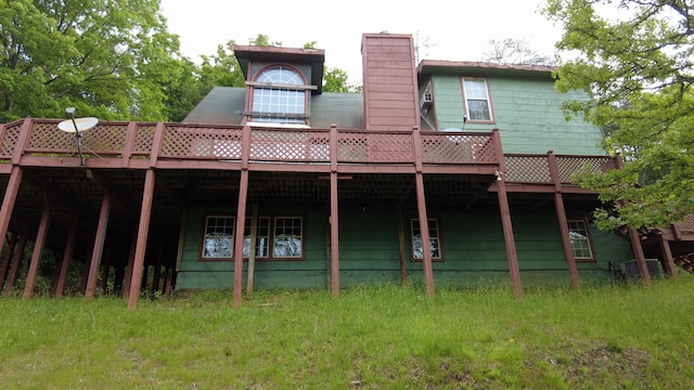 rear view of house featuring a wooden deck