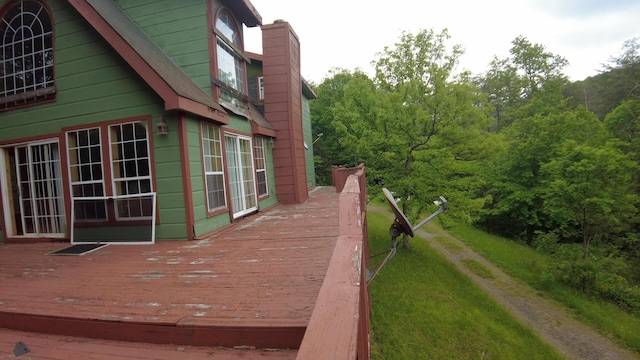 view of property exterior with a deck