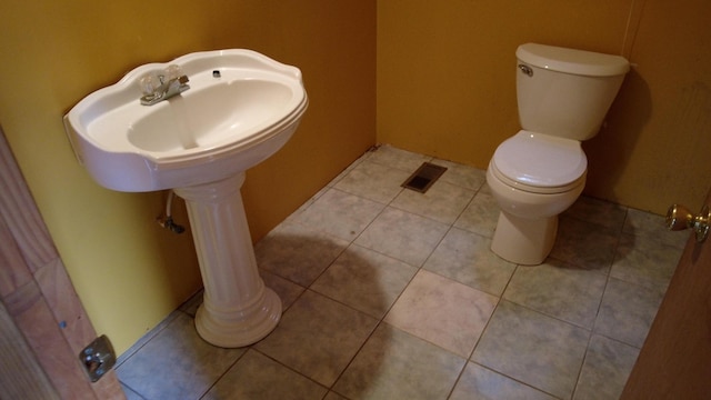 bathroom with tile patterned flooring and toilet