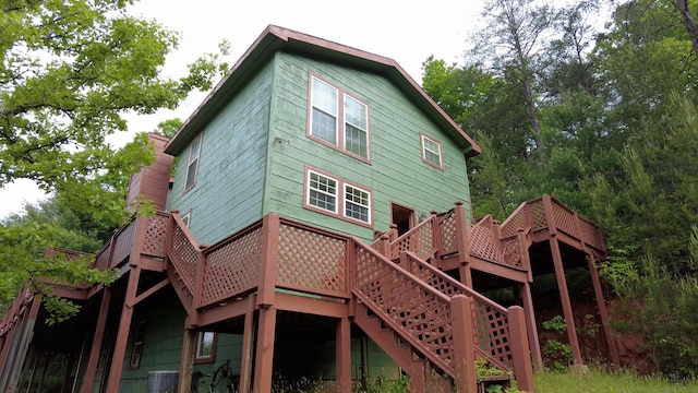 back of house featuring a wooden deck