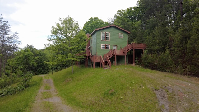 rear view of property featuring a wooden deck