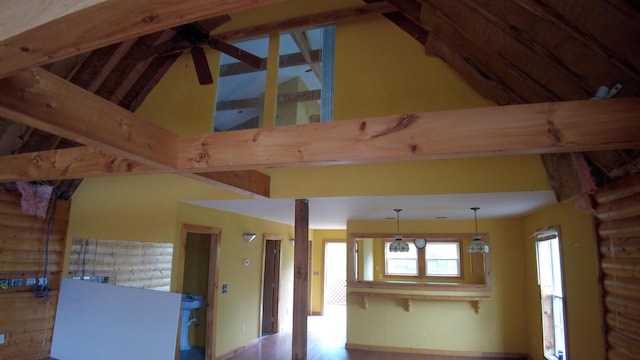 interior space featuring log walls, pendant lighting, high vaulted ceiling, and ceiling fan