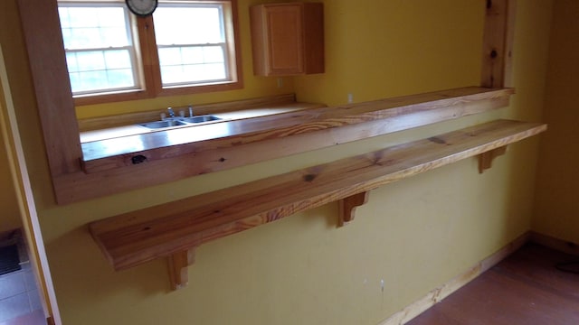 kitchen featuring a breakfast bar and sink