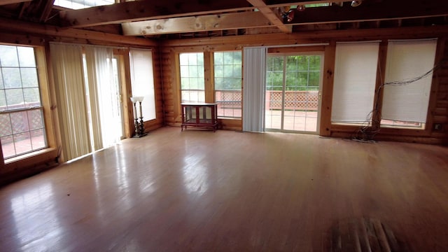 interior space with wood walls and hardwood / wood-style floors