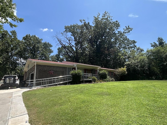 3535 Faye Dr SE, Cleveland, TN 37323 - view of front of home featuring driveway, a front yard, brick siding, and a garage