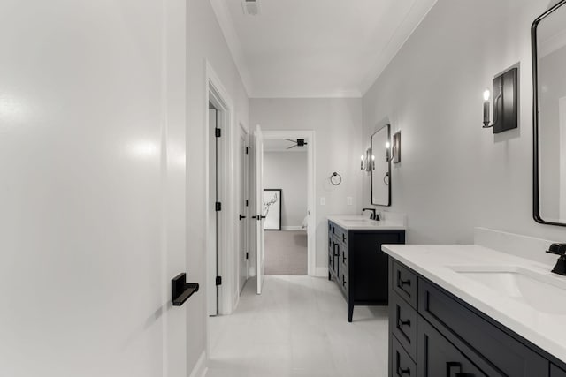 bathroom featuring tile patterned flooring, ceiling fan, crown molding, and vanity