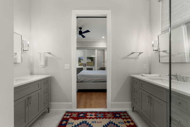 bathroom with ceiling fan, ornamental molding, and vanity