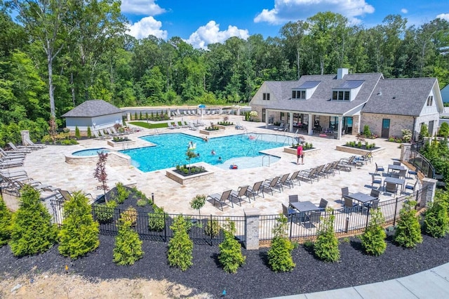 view of pool with a jacuzzi and a patio