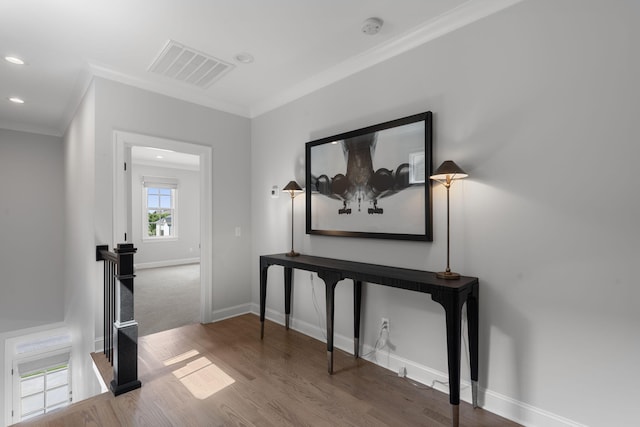 interior space featuring hardwood / wood-style floors and ornamental molding