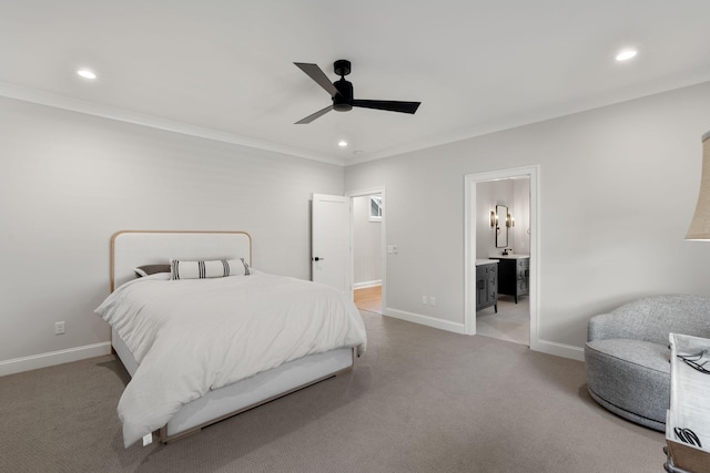 bedroom with ensuite bath, ceiling fan, light colored carpet, and ornamental molding