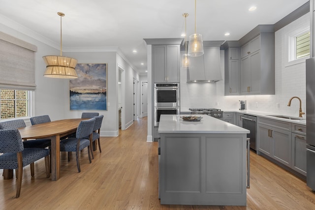 kitchen with gray cabinets, plenty of natural light, and pendant lighting