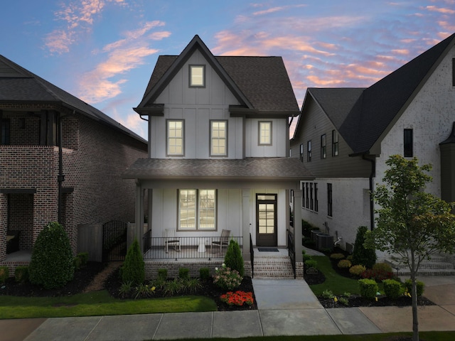 view of front of property with cooling unit and covered porch